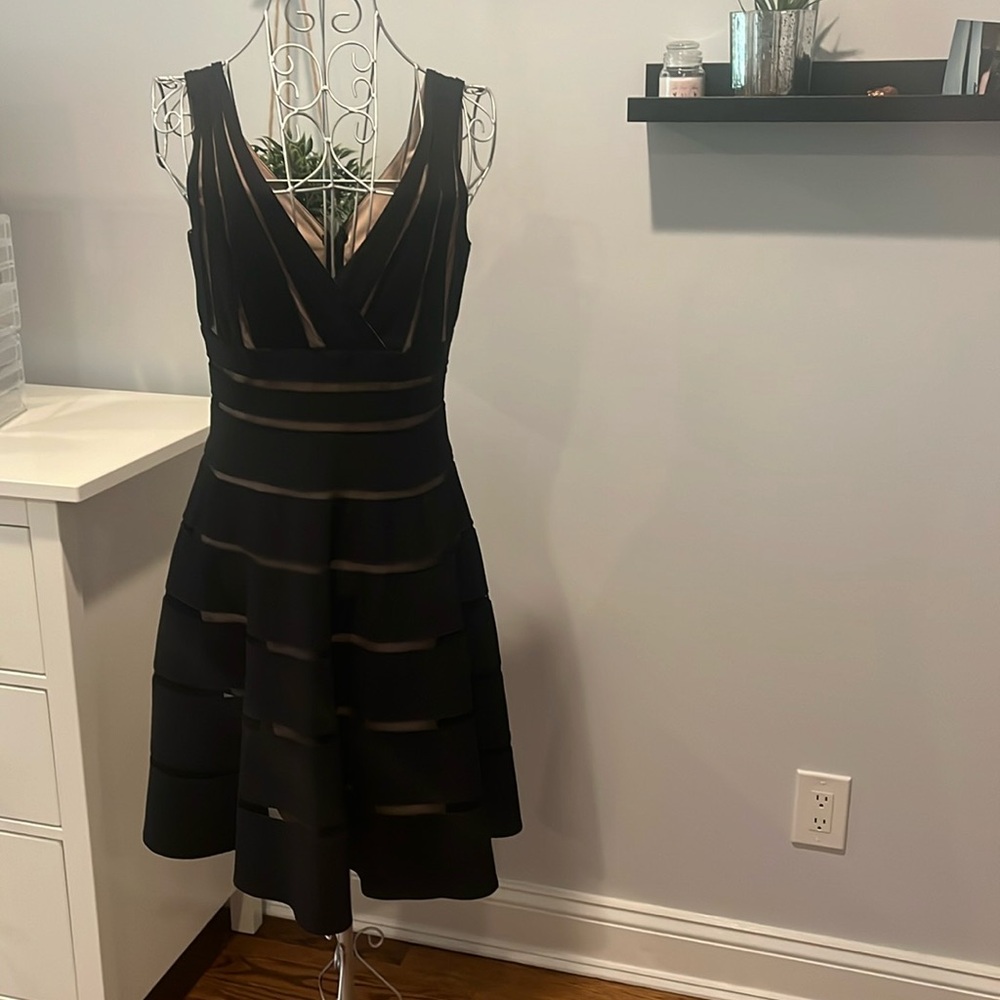 Black lace cocktail dress with nude mesh lining. Size 8